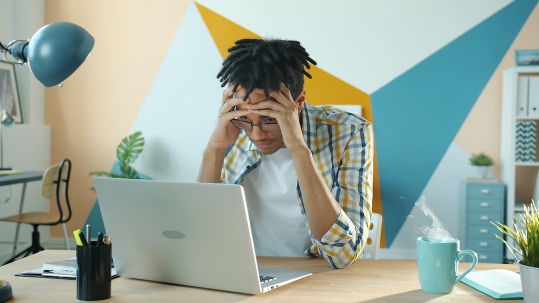 adult looking overwhelmed at desk trying to focus with ADHD